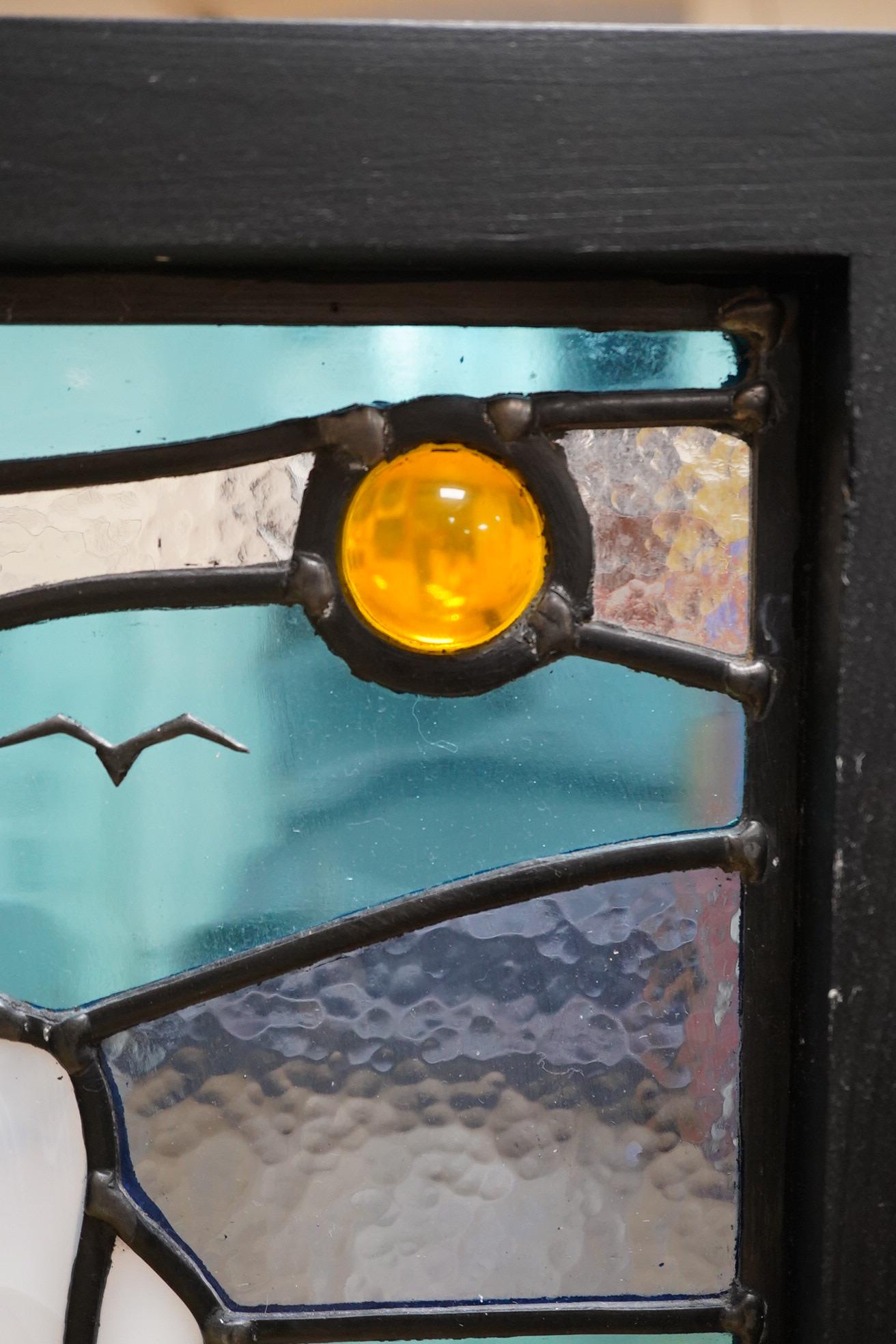A contemporary leaded stained glass panel, Beachy Head lighthouse, framed, 51cm high overall